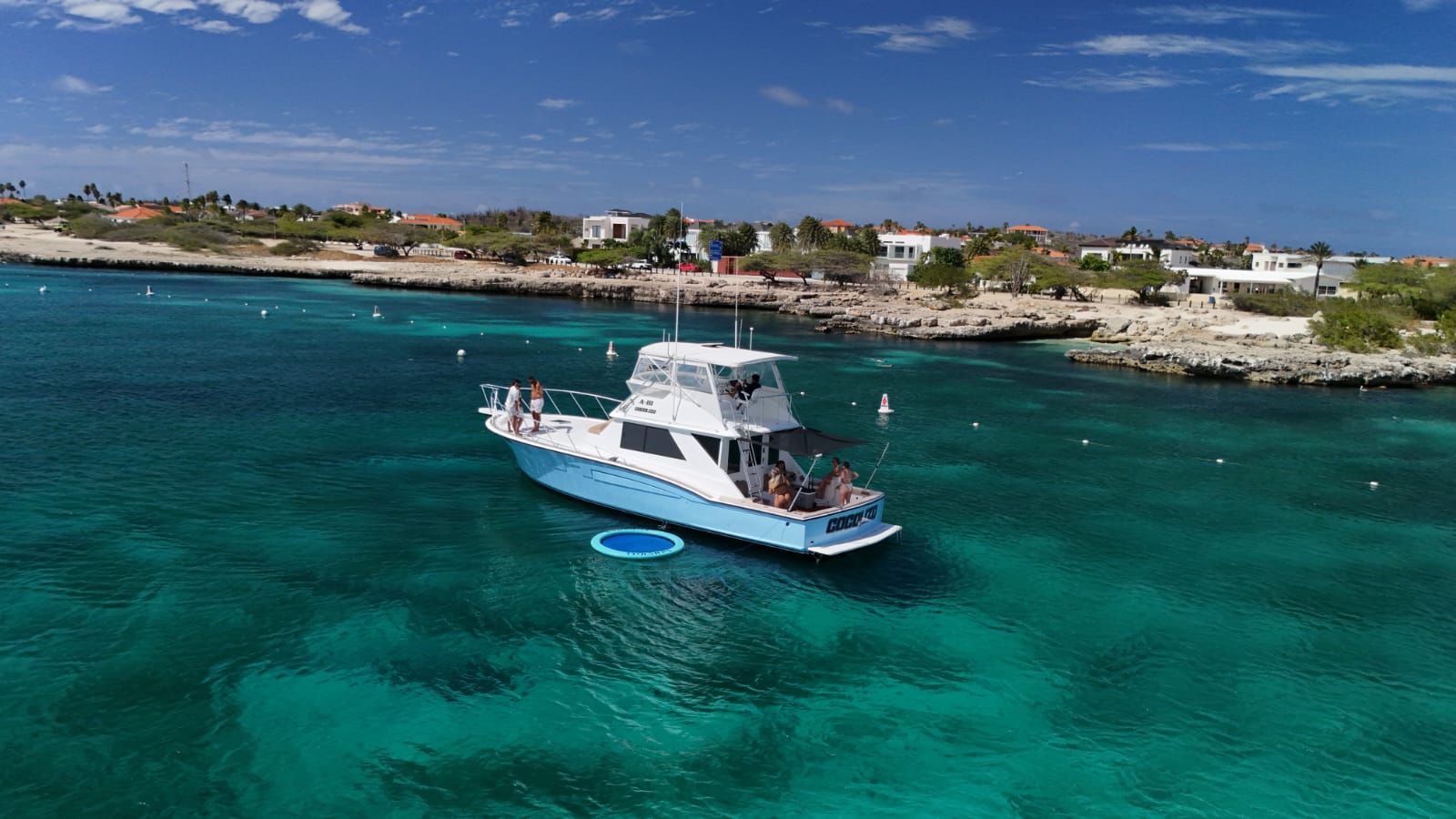 Guests relaxing on Cocolizo anchored in a calm Aruba cove